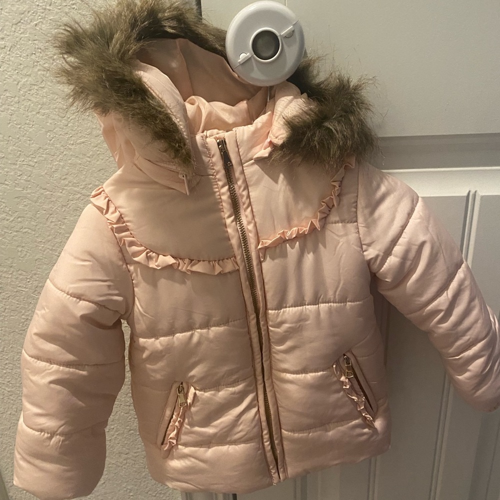 Stylish pink puffer jacket with faux fur hood